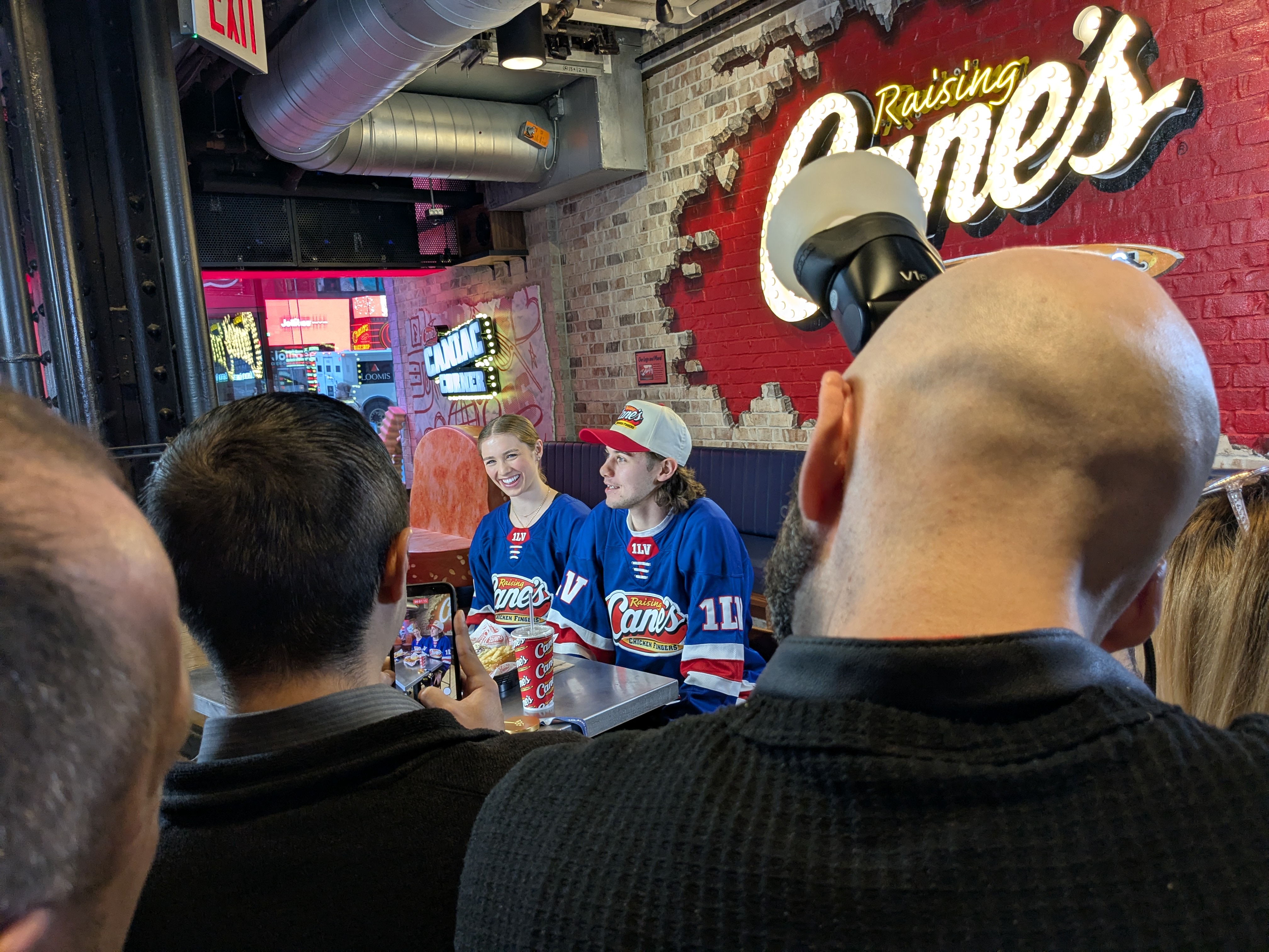Caroline Harvey and Jack Hughes answer questions at Raising Cane's in New York City. Photo credit: Ethan Lee